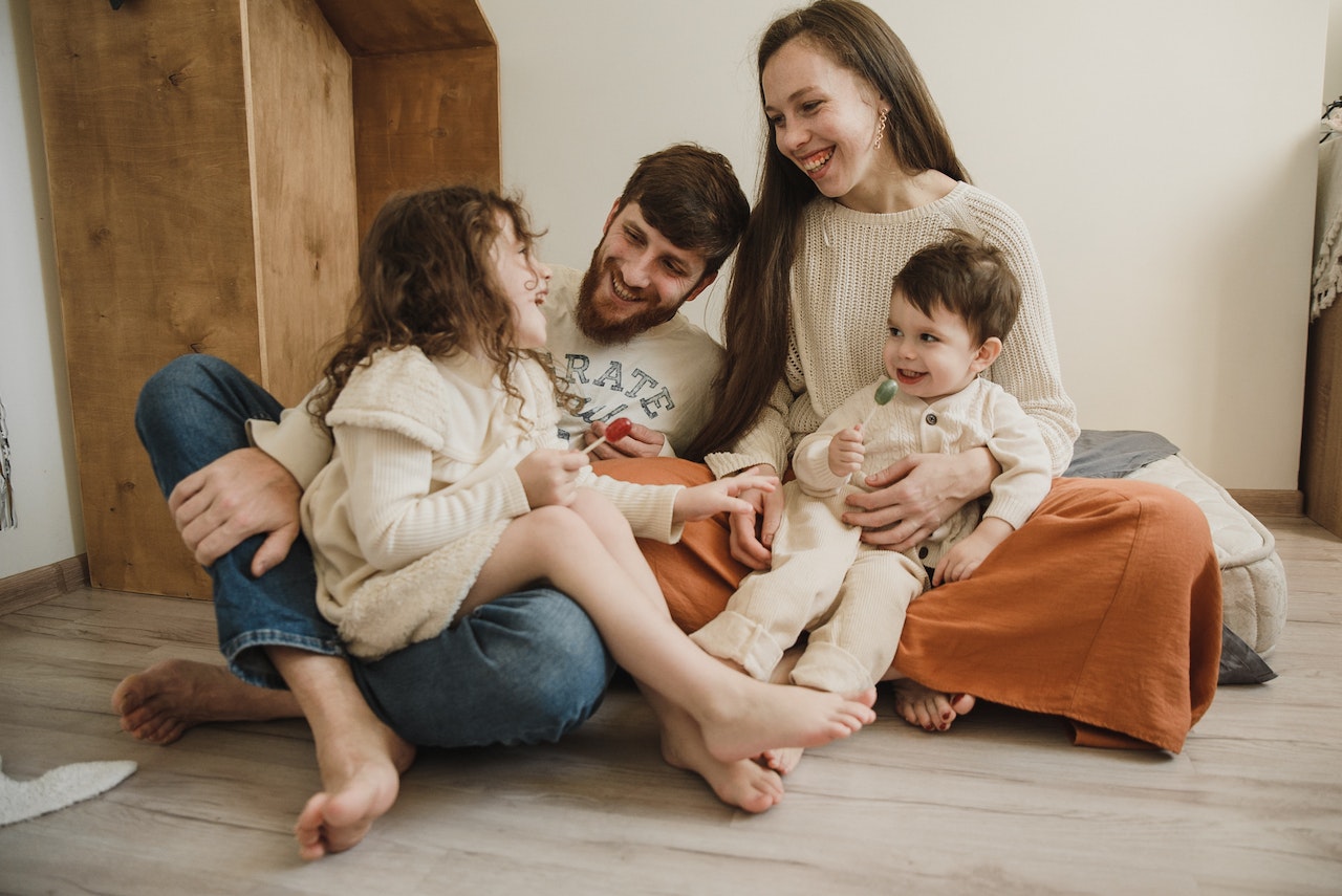 Family on bed by Arina Krasnikova